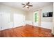 Cozy bedroom featuring hardwood floors, natural light, a ceiling fan and a built-in murphy bed at 636 N Center St, Statesville, NC 28677