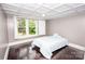 Cozy bedroom with coffered ceiling, hardwood floors, and large window views at 636 N Center St, Statesville, NC 28677