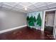 Bedroom showcasing a climbing wall, decorative ceiling, and hardwood floors at 636 N Center St, Statesville, NC 28677