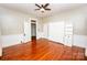 Cozy bedroom featuring hardwood floors, natural light, a ceiling fan and a built-in murphy bed at 636 N Center St, Statesville, NC 28677
