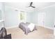 Bedroom featuring large window, ceiling fan, and neutral decor at 636 N Center St, Statesville, NC 28677