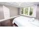 Bright bedroom featuring coffered ceiling and large window view at 636 N Center St, Statesville, NC 28677
