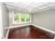 Bedroom featuring a large window, decorative ceiling, and hardwood floors at 636 N Center St, Statesville, NC 28677