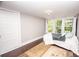 Simple bedroom with hardwood floors and natural light from the windows at 636 N Center St, Statesville, NC 28677