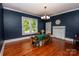 Charming dining area with blue walls, wood floors, and an elegant chandelier at 636 N Center St, Statesville, NC 28677
