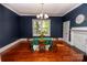 Dining room with hardwood flooring, a vintage chandelier, and a decorative table set at 636 N Center St, Statesville, NC 28677
