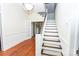 Inviting entryway with hardwood floors and staircase featuring carpeted treads at 636 N Center St, Statesville, NC 28677