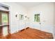 Inviting foyer with hardwood floors, paneled walls, and stylish white storage and exterior door at 636 N Center St, Statesville, NC 28677