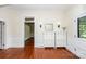 Bright foyer featuring hardwood floors, paneled walls, and stylish white storage at 636 N Center St, Statesville, NC 28677