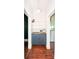 Hallway with hardwood flooring, white wainscotting, and a built-in cabinet and shelving at 636 N Center St, Statesville, NC 28677