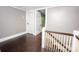 Upstairs hallway featuring hardwood floors and white trim at 636 N Center St, Statesville, NC 28677