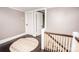 Upstairs hallway featuring dark wood floors and a neutral color scheme at 636 N Center St, Statesville, NC 28677