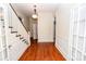 Hallway featuring hardwood floors, wainscotting and a beautiful staircase with white trim at 636 N Center St, Statesville, NC 28677