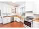 Kitchen with butcher block countertops, white cabinets, stainless steel appliances, and hardwood floors at 636 N Center St, Statesville, NC 28677
