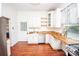 Kitchen featuring wooden countertops, white cabinets, a stainless steel dishwasher, and wood floors at 636 N Center St, Statesville, NC 28677