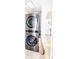 Laundry room with modern, stacked washer and dryer and shelving for storage at 636 N Center St, Statesville, NC 28677