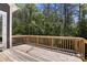 Wooden back deck overlooking lush trees at 6782 Kingfisher Ct, Denver, NC 28037