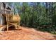 Image shows a spacious backyard with a wooden deck with unfinished landscaping at 6782 Kingfisher Ct, Denver, NC 28037