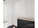 Bathroom featuring a bathtub, dark cabinets and white countertop at 6782 Kingfisher Ct, Denver, NC 28037