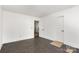 Bedroom with wood floors, white trim and doorways to additional rooms at 6782 Kingfisher Ct, Denver, NC 28037