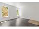 Bright, spacious bedroom featuring hardwood floors and two large windows at 6782 Kingfisher Ct, Denver, NC 28037