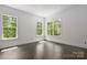 Sunlit bedroom with large windows and hardwood floors at 6782 Kingfisher Ct, Denver, NC 28037