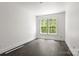 Light-filled bedroom with hardwood floors and a large window offering scenic views at 6782 Kingfisher Ct, Denver, NC 28037