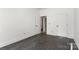 Bright bedroom featuring hardwood floors, multiple doors, and neutral décor at 6782 Kingfisher Ct, Denver, NC 28037