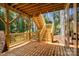 New wooden deck with wooden stairs leading to the backyard surrounded by green trees at 6782 Kingfisher Ct, Denver, NC 28037