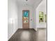 Inviting entryway with hardwood floors and a wood-framed glass front door to let the light in at 6782 Kingfisher Ct, Denver, NC 28037