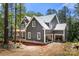Two story home with gray siding, white trim and an attached two car garage in a wooded setting at 6782 Kingfisher Ct, Denver, NC 28037