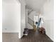 Hallway with wood floors leading to staircase and open floorplan at 6782 Kingfisher Ct, Denver, NC 28037