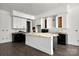 Bright kitchen featuring an island with white countertops and custom white cabinets at 6782 Kingfisher Ct, Denver, NC 28037