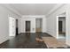 Living room with multiple doorways, recessed lighting and dark wood floors at 6782 Kingfisher Ct, Denver, NC 28037