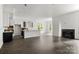Open-concept living room with white walls, fireplace, and hardwood floors at 6782 Kingfisher Ct, Denver, NC 28037