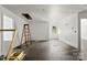 Large living room features a ladder, dark wood floors, bright light and recessed lighting fixtures at 6782 Kingfisher Ct, Denver, NC 28037