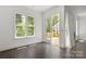 Bright, airy living room with hardwood floors, large window, and sliding doors to deck at 6782 Kingfisher Ct, Denver, NC 28037
