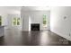 Spacious living room featuring a fireplace with shiplap accent and hardwood floors at 6782 Kingfisher Ct, Denver, NC 28037