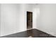 White room featuring a wooden door and hardwood floors at 6782 Kingfisher Ct, Denver, NC 28037