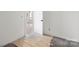 White room featuring a wooden door and hardwood floors at 6782 Kingfisher Ct, Denver, NC 28037