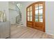 Inviting foyer with wood floors, arched doorway, and staircase with iron railing at 7209 Alexander Rd # 3, Charlotte, NC 28270