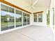 Covered outdoor patio with a ceiling fan and views of the spacious backyard and neighboring umbrellas at 7209 Alexander Rd # 3, Charlotte, NC 28270
