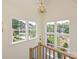 Staircase with large windows providing ample natural light and views of landscaped yards at 7209 Alexander Rd # 3, Charlotte, NC 28270