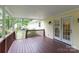 Covered back porch with stained wood floorboards and white French doors leading into the house at 785 Sanside Dr, York, SC 29745