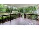 Covered back porch with stained wood floorboards, overlooking the backyard and shed at 785 Sanside Dr, York, SC 29745