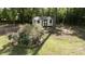 Backyard with a small shed surrounded by trees and bushes at 785 Sanside Dr, York, SC 29745