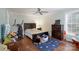 Neutral bedroom showcasing dark furniture, hardwood floors, and a large window at 785 Sanside Dr, York, SC 29745