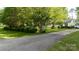 Long driveway leading up to the yellow home surrounded by mature trees at 785 Sanside Dr, York, SC 29745