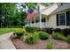 Beautiful front yard featuring flower beds, green bushes, a sidewalk, and a charming home with a welcoming porch at 785 Sanside Dr, York, SC 29745