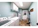 Functional laundry room equipped with modern appliances and ample shelving at 785 Sanside Dr, York, SC 29745